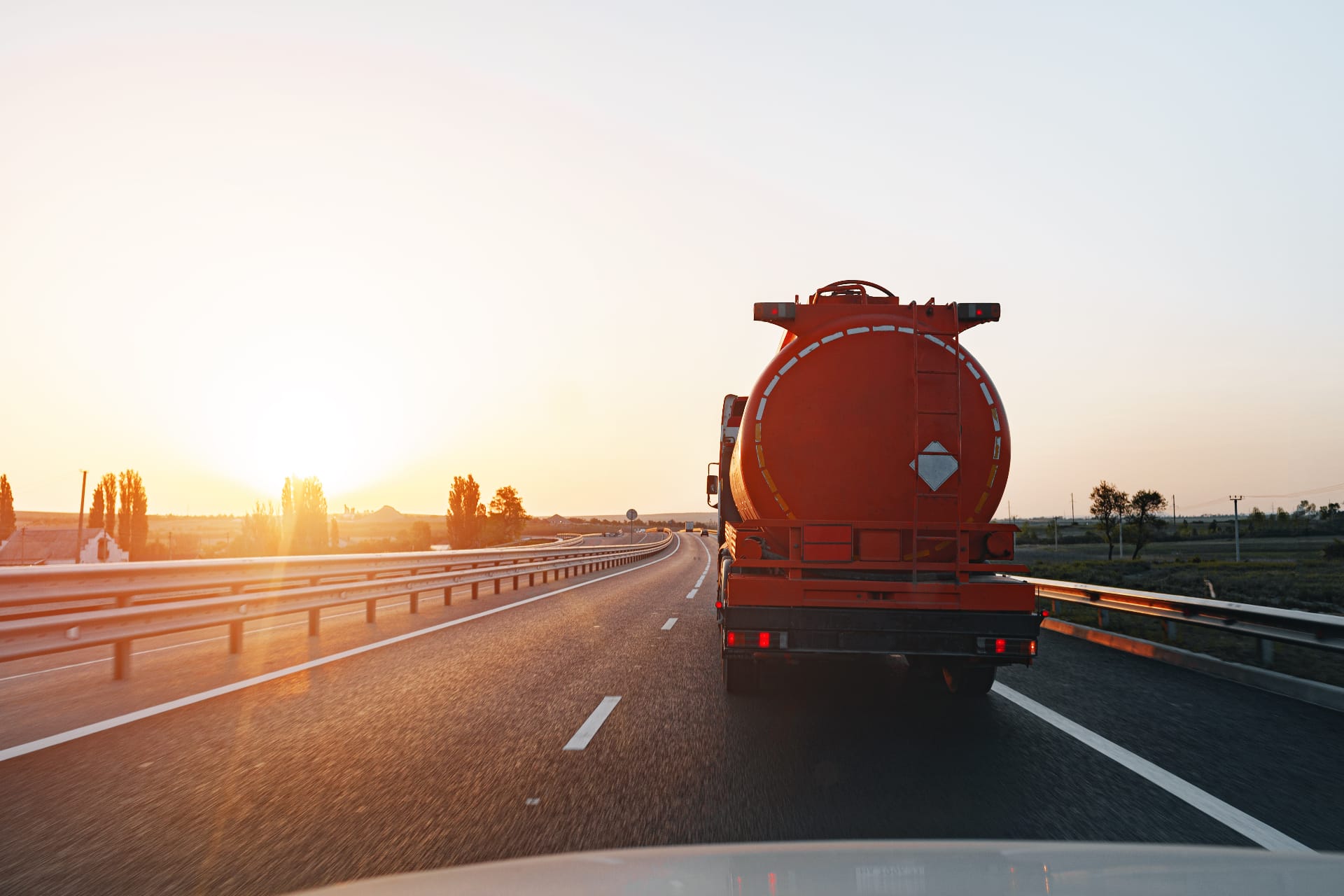 renova-used-cooking-oil-collection-truck.jpg A Renova tanker truck on the highway at sunrise, representing our reliable, market-based system for used cooking oil collection and recycling.